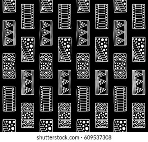 Seamless vector pattern. Black and white geometrical background with hand drawn decorative tribal elements. Print with ethnic, folk, traditional motifs. Graphic vector illustration.