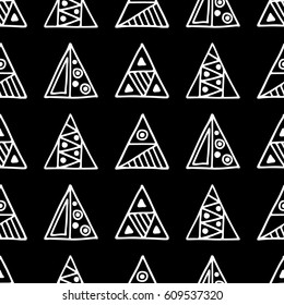 Seamless vector pattern. Black and white geometrical background with hand drawn decorative tribal elements. Print with ethnic, folk, traditional motifs. Graphic vector illustration.