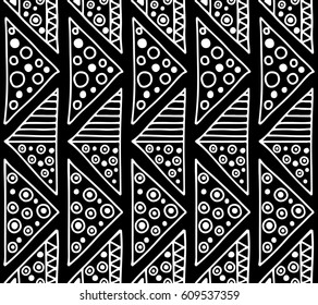 Seamless vector pattern. Black and white geometrical background with hand drawn decorative tribal elements. Print with ethnic, folk, traditional motifs. Graphic vector illustration.