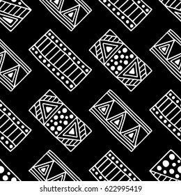 Seamless vector pattern. Black and white geometrical background with hand drawn decorative tribal elements. Print with ethnic, folk, traditional motifs. Graphic vector illustration.