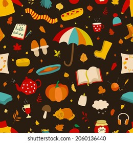 Seamless vector pattern. Bright autumn objects on dark background. Umbrella, pumpkin, scarf, leaf. Ideal for fabric, wrapping, wallpaper, web site. You can print on clothes, blankets, pillows.