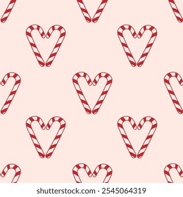 Seamless vector pattern with Candy Cane in heart shape. Merry christmas and happy new year. Holiday hand drawn print in red and pink colors