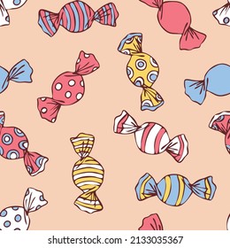 Seamless vector pattern with candy sweets on pastel yellow background. Simple hand drawn toffee wallpaper design. Decorative happy food fashion textile.