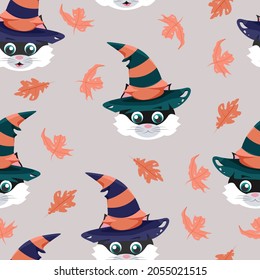 Seamless vector pattern with cat in striped witch hat, maple and oak leaves isolated on gray background. Autumn cartoon elements.