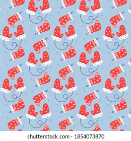 Seamless vector pattern of Christmas mittens and socks. Christmas gift blue background 