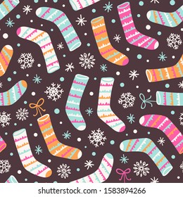 Seamless vector pattern with Christmas socks and snowflakes.