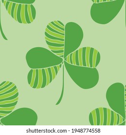 Seamless vector pattern with clover leaf on green background. Simple good luck wallpaper design. Decorative symbol fashion textile.