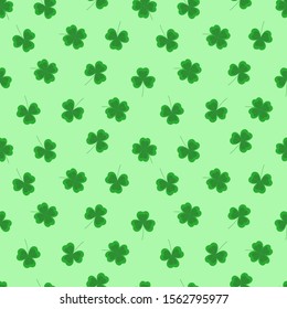 Seamless vector pattern with clover leaves on a light green background.