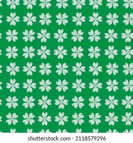 Seamless vector pattern of clover quatrefoil leaf on green background