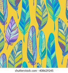 Seamless vector pattern with colored feathers on yellow. Hand drawn illustration. Bohemian  style feathers for prints,wrapping,  fabric and other seamless design. Seamless texture of graphic feather.