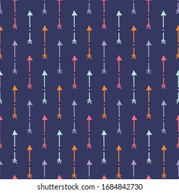 Seamless vector pattern of colorful boho arrows with dark ultramarine background