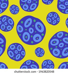 Seamless vector pattern colorful design illustration abstract purple planets and asteroids on yellow background. The design is perfect for wallpaper, wrapping paper, packaging, textiles, clothes