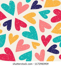 Seamless vector pattern with colorful hearts.