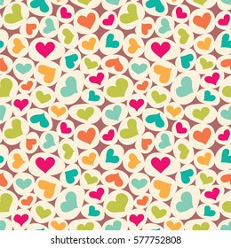 Seamless vector pattern with colorful hearts and ellipses.