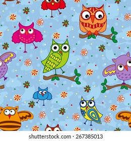 Seamless vector pattern with colorful ornamental owls on a light blue background