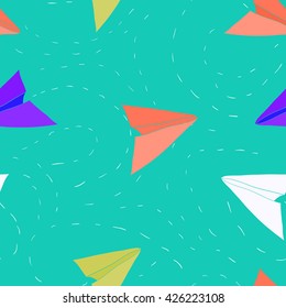 Seamless vector pattern with colorful paper planes. Bright background with blue, red, green & white paper planes flying in the sky. Fun background. Outdoor games background. Paper airplanes background
