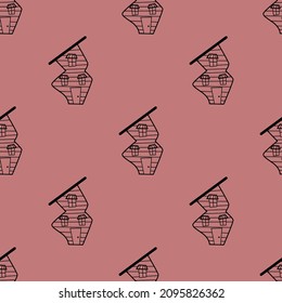 Seamless vector pattern of contour houses in doodle style on pink background.