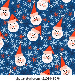 Seamless vector pattern with cute colorful snowmen in red hats and blue, red and navy snowflakes. Bright red, white, blue winter pattern. Winter festive background for print, wrapping paper, textile, 