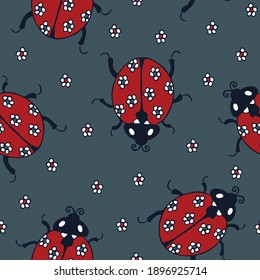 Seamless vector pattern with cute ladybugs on dark blue background. Simple ladybirds wallpaper design. Insects and flowers fashion textile for children.