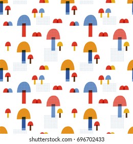Seamless vector pattern: cute mushrooms. For autumn greeting cards, scrapbook, wallpaper, gift paper, pattern fills, web page background. Fashion baby print in red, yellow and blue colors.