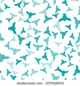Seamless vector pattern with cyan, teal owls. Repetitive background with vector flat birds turquoise, aqua, green-blue color. Owls in the repetitive seamless vector pattern.