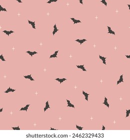 Seamless vector pattern dark gray spooky bats silhouettes on pink, halloween. Textile, scrapbook