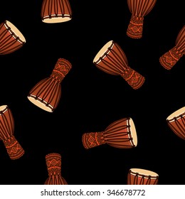 Seamless vector pattern of ethnic drums on a black background, painted by hand.