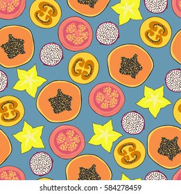 Seamless vector pattern. Exotic fruits and leaves pattern on the bright blue background. Carambola, tamarillo or tomato tree fruit, papaya, dragon fruit and soursop fruit bright pattern.