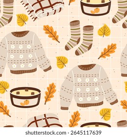 Seamless vector pattern featuring cozy sweaters, socks, and autumn leaves. Hand-drawn design ideal for warm seasonal textiles, wrapping paper, and childrens clothing.