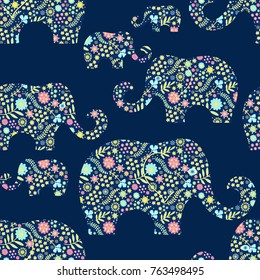 Seamless vector pattern with floral elephants on blue background