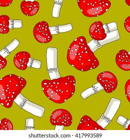 Seamless vector pattern of fly agaric on a green background. Wrapping paper.