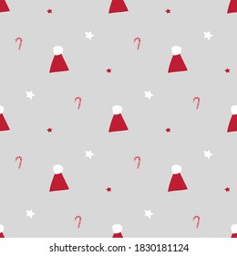 Seamless vector pattern with funny xmas stuff including Santa hat, christmas sweets and stars in red and white color theme. Suitable for wrapping paper, party invitations, greeting cards, banners, etc