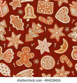 Seamless vector pattern with gingerbread cookies on red background. Christmas ornament