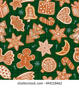 Seamless vector pattern with gingerbread cookies on green background. Christmas decorative wallpaper