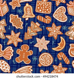 Seamless vector pattern with gingerbread cookies on blue background. Christmas ornament