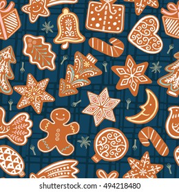 Seamless vector pattern with gingerbread cookies on dark blue background. Christmas wallpaper