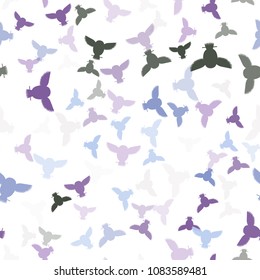 Seamless vector pattern with green, blue, lilac, violet owls. Repetitive background with vector flat multicolored birds. Owls in the repetitive seamless vector pattern.