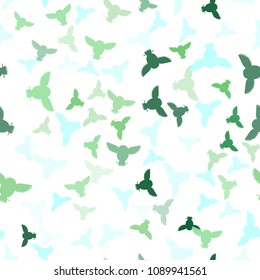 Seamless vector pattern with green and blue owls. Repetitive background with vector multicolored flat birds. Owls in the repetitive seamless vector pattern.