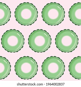 Seamless vector pattern with green inflatable lifebuoy on pink background