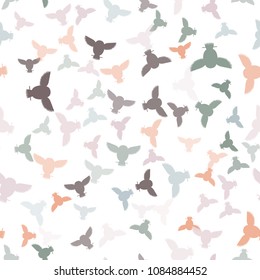 Seamless vector pattern with grey, orange, pink, brown owls. Repetitive background with vector flat multicolored birds. Owls in the repetitive seamless vector pattern.