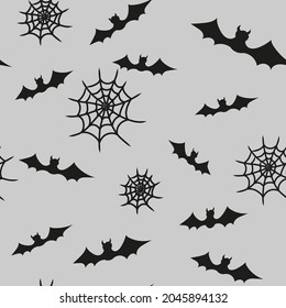 Seamless vector pattern for Halloween. A pattern with bats and cobwebs. Black Halloween symbols on a gray background. Background for clothing, websites, curtains, wallpaper in the style of horror.