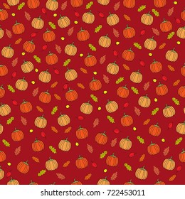 Seamless vector pattern. Halloween bright pattern with pumpkins and autumn leaves on the red background.