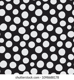 Seamless vector pattern of hand drawn polka dots, random spots in various sizes. Big and small dark circles in black and white. Stylish monochrome abstract background. Retro simple design tiles.