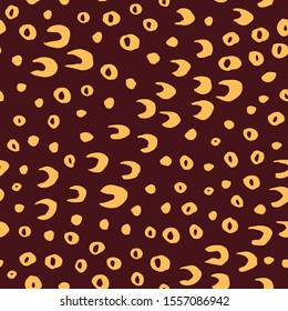 Seamless vector pattern with hand drawn beige circles, horseshoes and dots scattered on brown background. Modern abstract chaotic design for print or textile. Ink brush strokes simple design