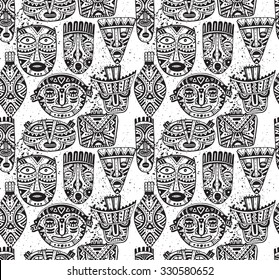 Seamless vector pattern with hand drawn fancy masks in african style. Black and white tribal ethnic illustration.