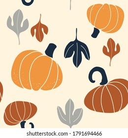 Seamless vector pattern with the image of autumn leaves, pumkins, nuts stylized in a flat style, Cozy and cute. Trendy colors of the autumn are perfect for scrapbooking paper, textile, fabric, card