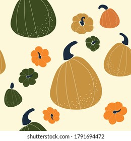Seamless vector pattern with the image of autumn leaves, pumkins, nuts stylized in a flat style, Cozy and cute. Trendy colors of the autumn are perfect for scrapbooking paper, textile, fabric, card