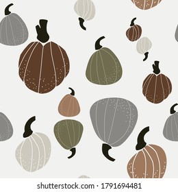 Seamless vector pattern with the image of autumn leaves, pumkins, nuts stylized in a flat style, Cozy and cute. Trendy colors of the autumn are perfect for scrapbooking paper, textile, fabric, card