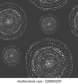 Seamless vector pattern of ink watercolor dots circle shapes. Grey background, white elements. Big and small spiral circles. 