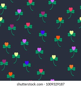 Seamless vector pattern with irish symbol of St Patrick Day - shamrocks, decorated with multicolored hearts, symbol of love. Contrast background with bright colors.